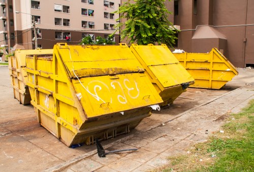 Construction site with builders managing waste clearance in Highgate